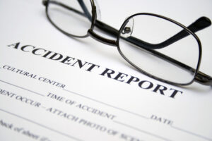 Accident Report with pair of glasses on top
