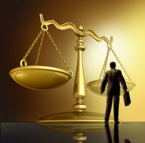 Scales of Justice with silhouette of attorney under it 
